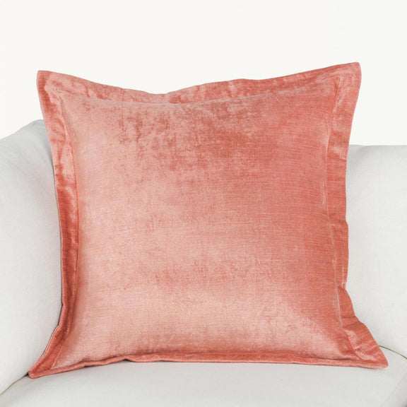 Coral pink square throw pillow with piped edges and soft textured finish