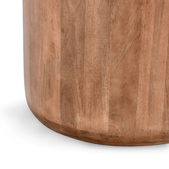 Umber wood round table base with vertical grain and curved bottom edge.