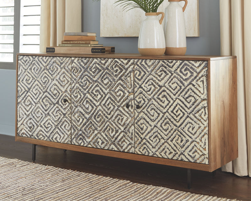 Low accent cabinet with patterned two-door front, white-and-black geometric doors, black legs.