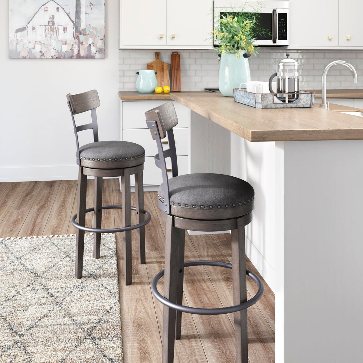 Two tall swivel barstools with gray upholstered round seats and nailhead-trimmed backs