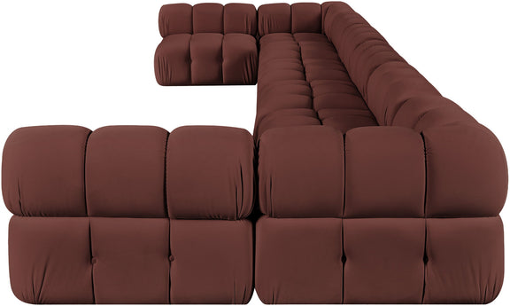 Dark red modular sectional sofa with tufted cushions and deep, rounded backrest