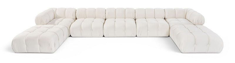 White modular sectional sofa with tufted cushions and rounded armrests, curved layout