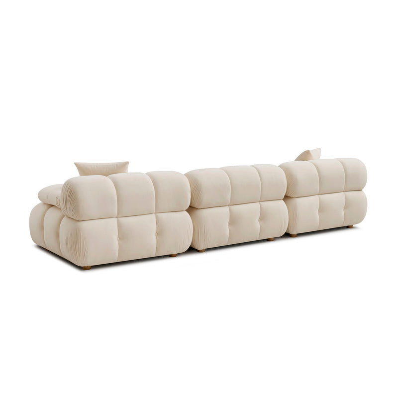 Cream modular sectional sofa viewed from the side with rounded arm and seats
