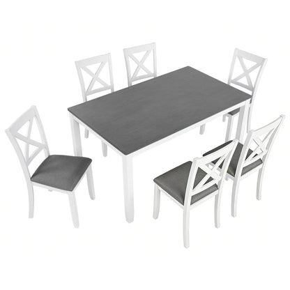 Rectangular dining table with dark tabletop and four white chairs with gray seat cushions