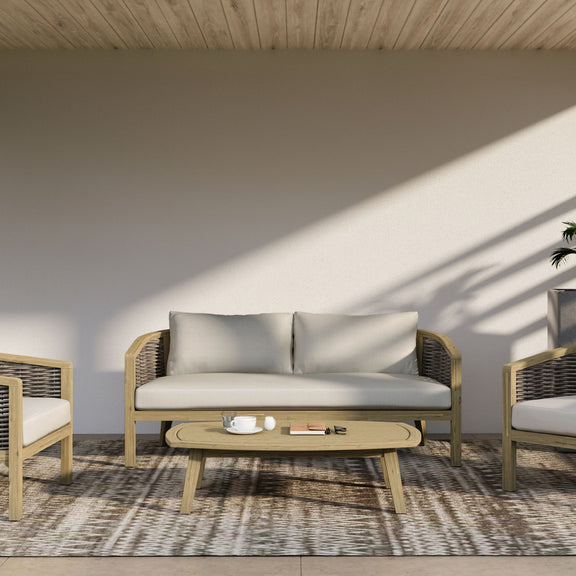 Outdoor sofa with beige cushions, light wood frame, and dark woven wicker arms