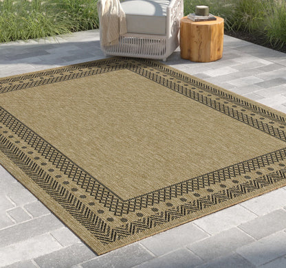 Light brown polypropylene area rug with dark zigzag edge and geometric border pattern.