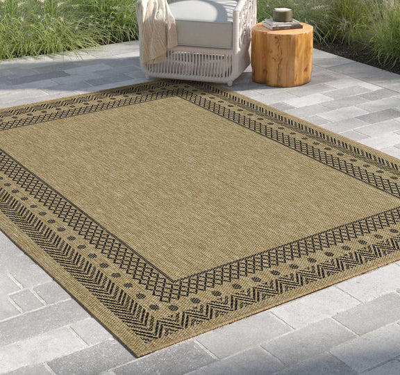 Light brown polypropylene area rug with dark zigzag edge and geometric border pattern.