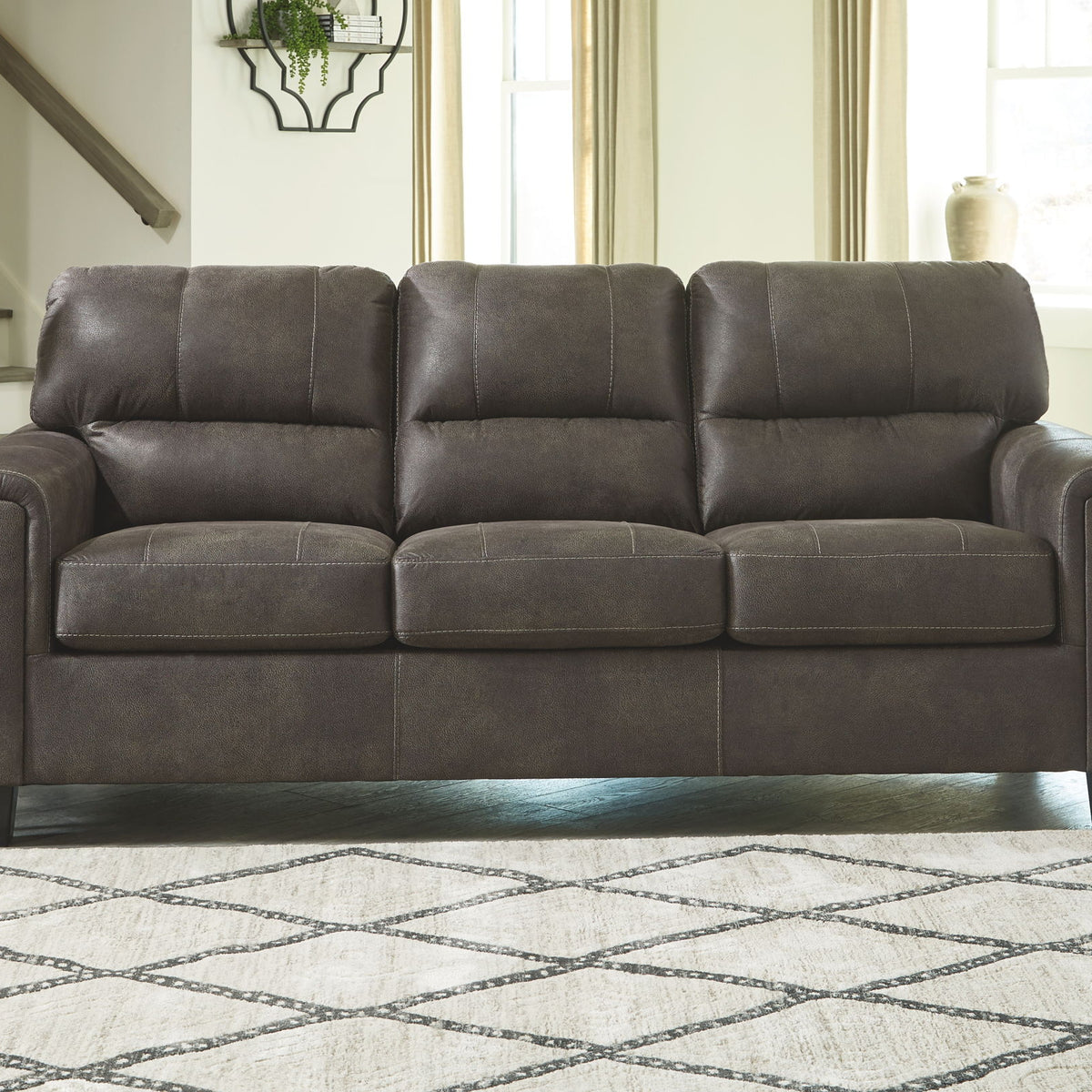 Smoke gray queen sofa sleeper with mattress extended and three tufted back cushions