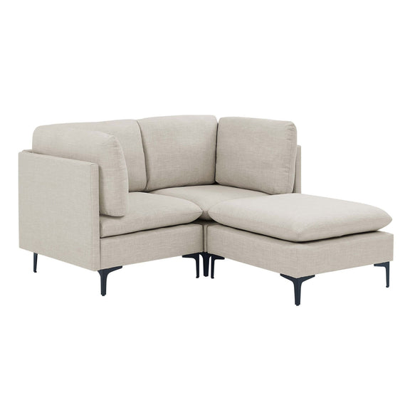 Beige upholstered modular sectional with tall legs and chaise-style ottoman extension