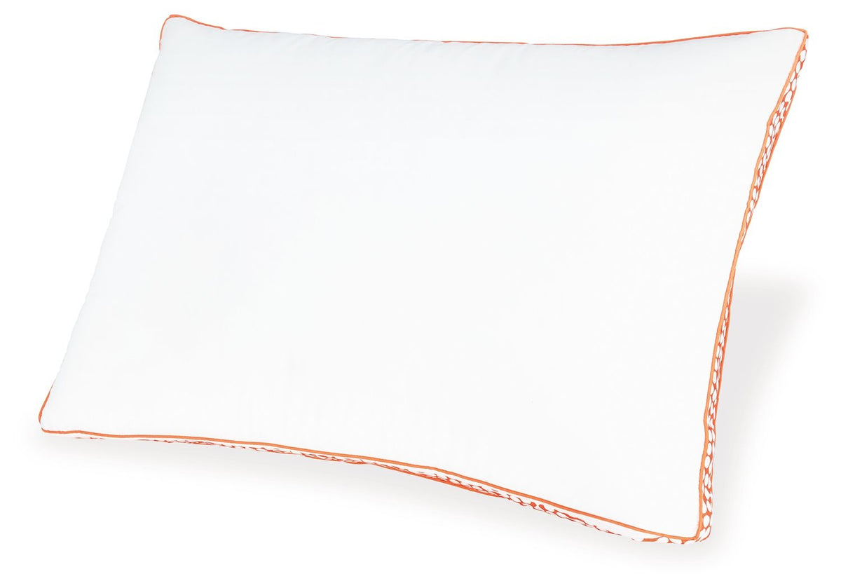 White pillow with orange piping and patterned edge trim
