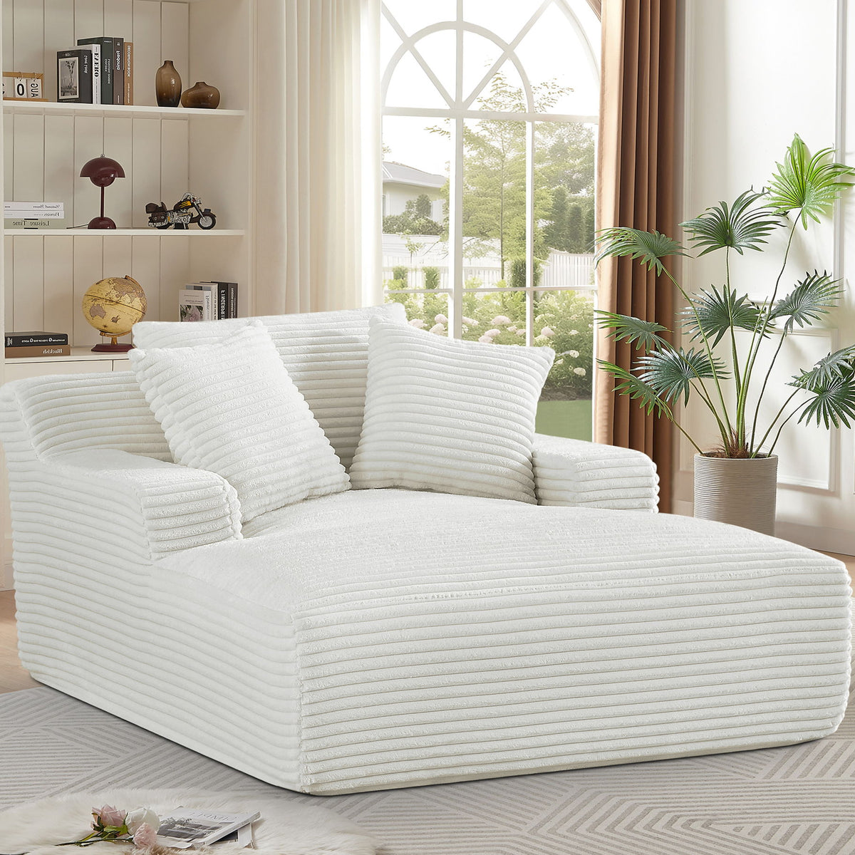 Cream oversized chaise lounge sleeper with ribbed foam cushions and three throw pillows