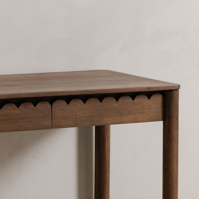 Vintage-brown desk tabletop with scalloped apron detail and drawer front