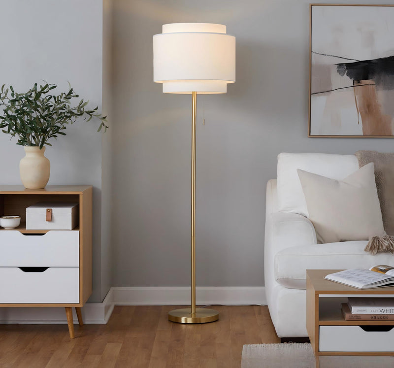 Gold-tone contemporary floor lamp with white fabric drum shade and round base