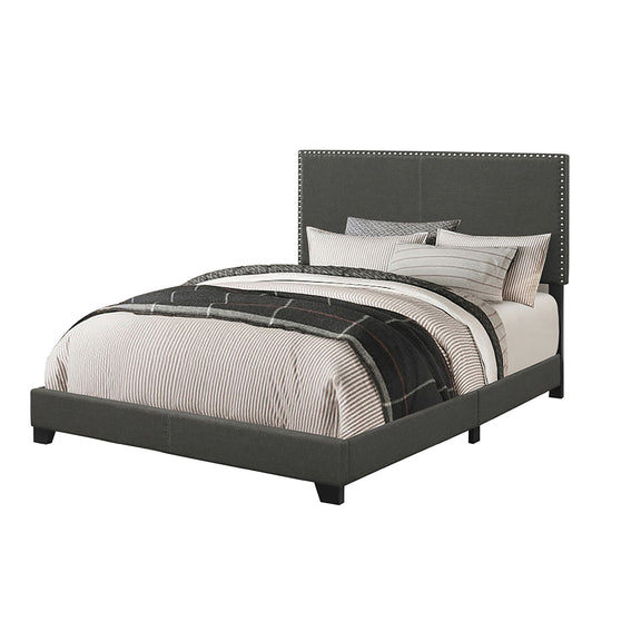 Dark gray upholstered bed with nailhead-trimmed headboard and platform base
