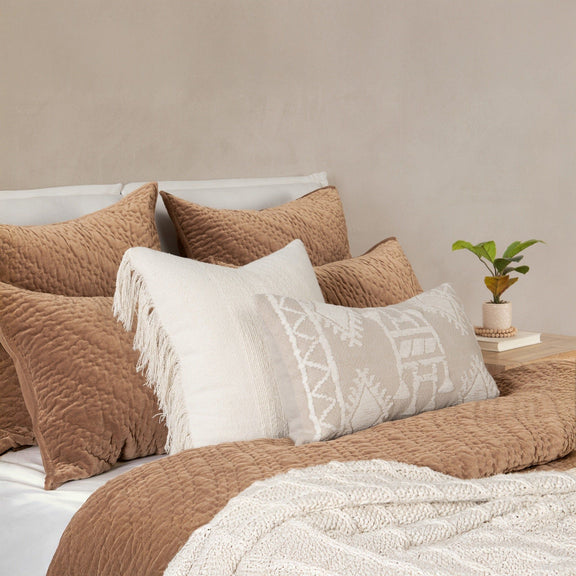 Quilted velvet bedding set in tan/brown with decorative pillows and white accent panel