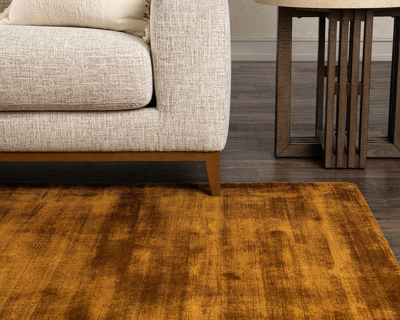 Mustard tan distressed area rug with vintage-style mottled texture