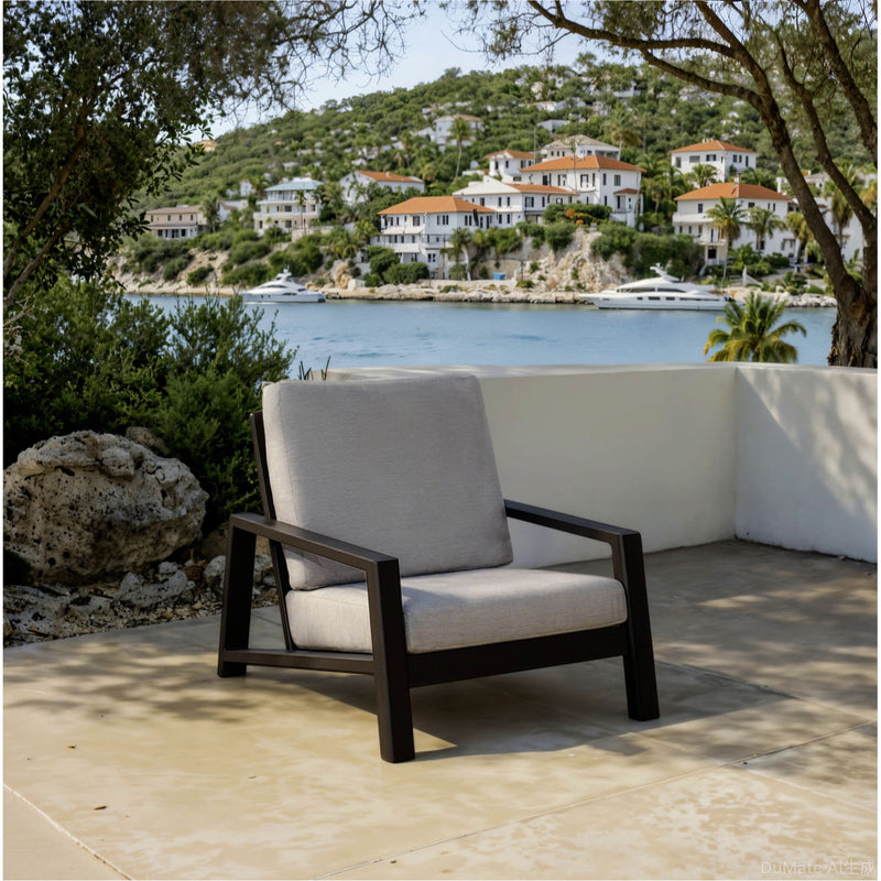 Gray lounge chair with dark frame and off-white throw pillow