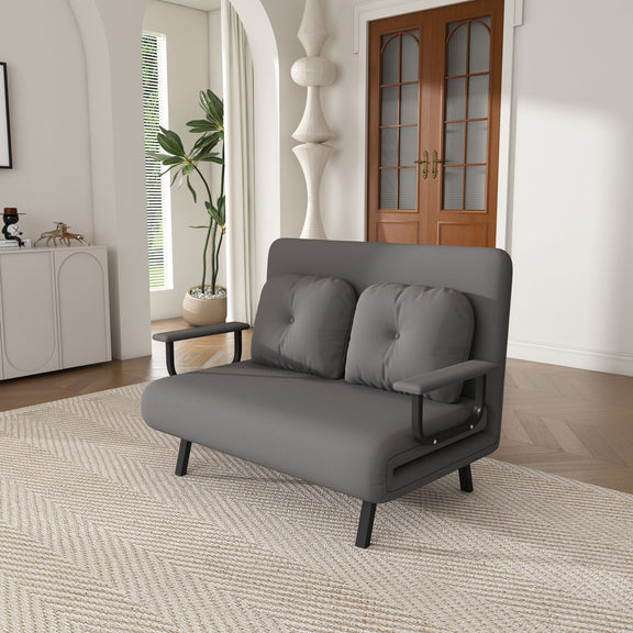 Convertible sofa bed, dark gray fabric with two bolsters and black metal legs.