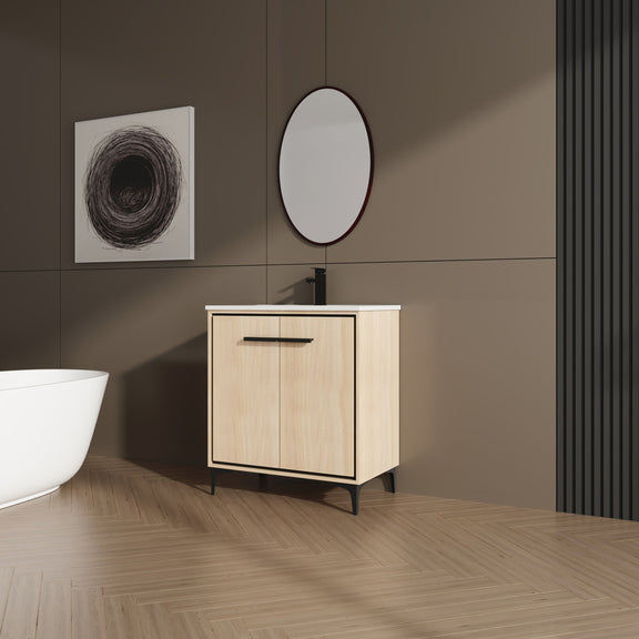 Light brown bathroom vanity cabinet with white sink basin and black bar handle, two doors