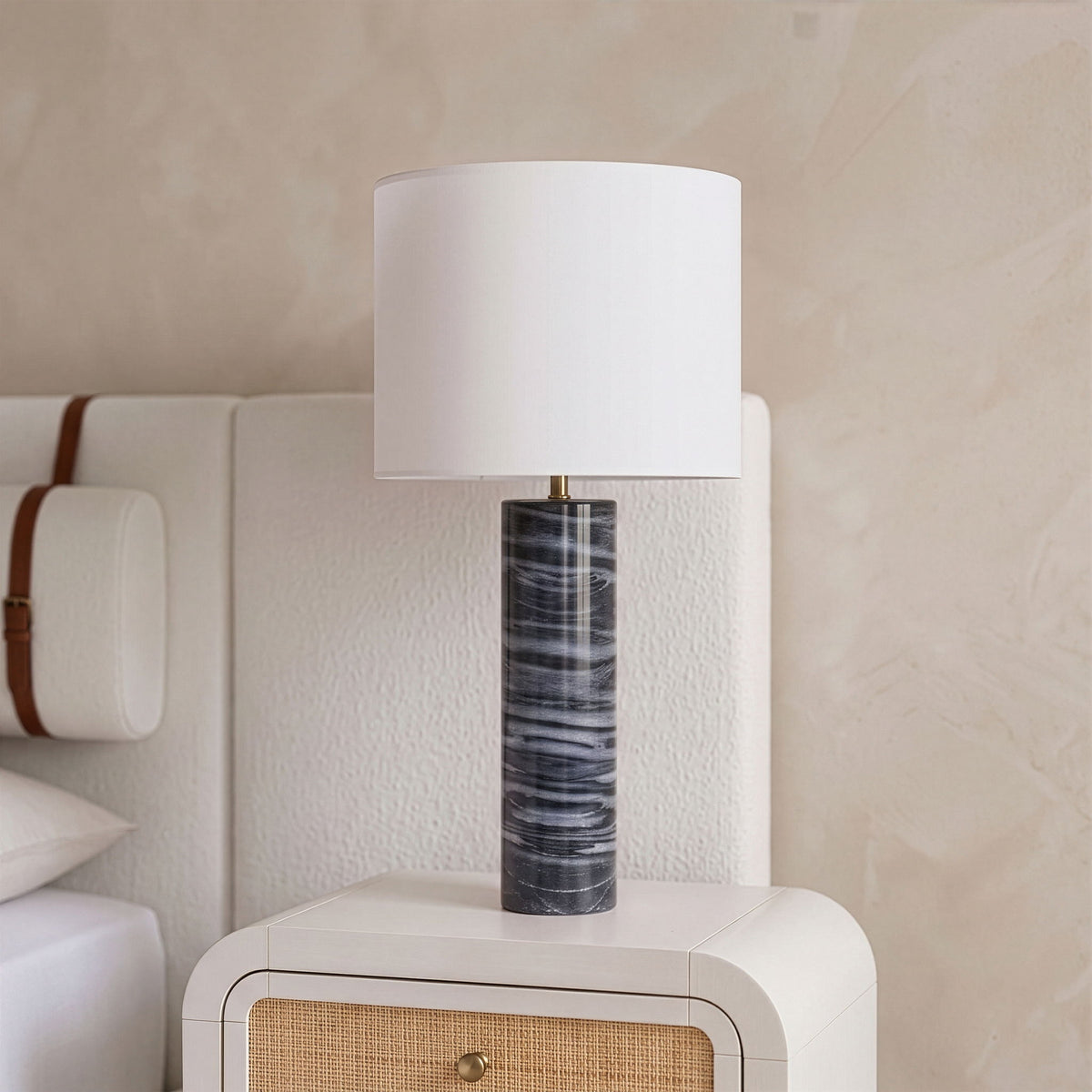 Textured fabric table lamp with white drum shade and dark gray marbled cylindrical base