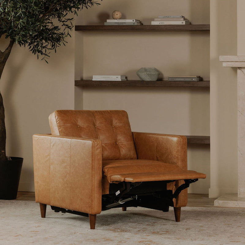 Tan leather recliner chair with footrest extended, showing the reclining mechanism beneath