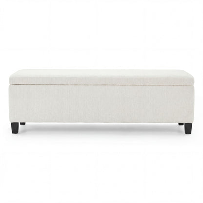 Upholstered storage ottoman bench in light beige fabric with tufted lid and dark feet