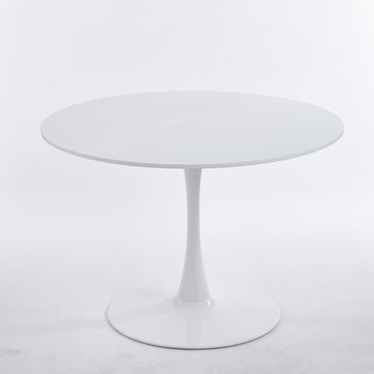 Round dining table with white tabletop and white tulip pedestal base