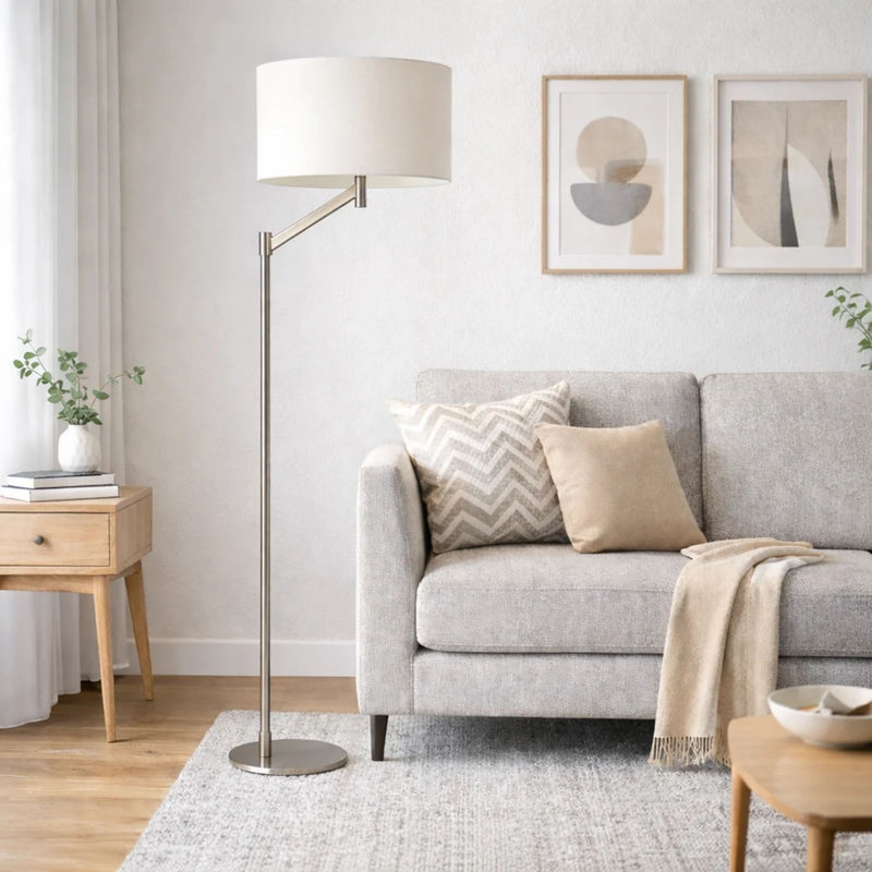 Brushed nickel floor lamp with white linen drum shade and weighted round base