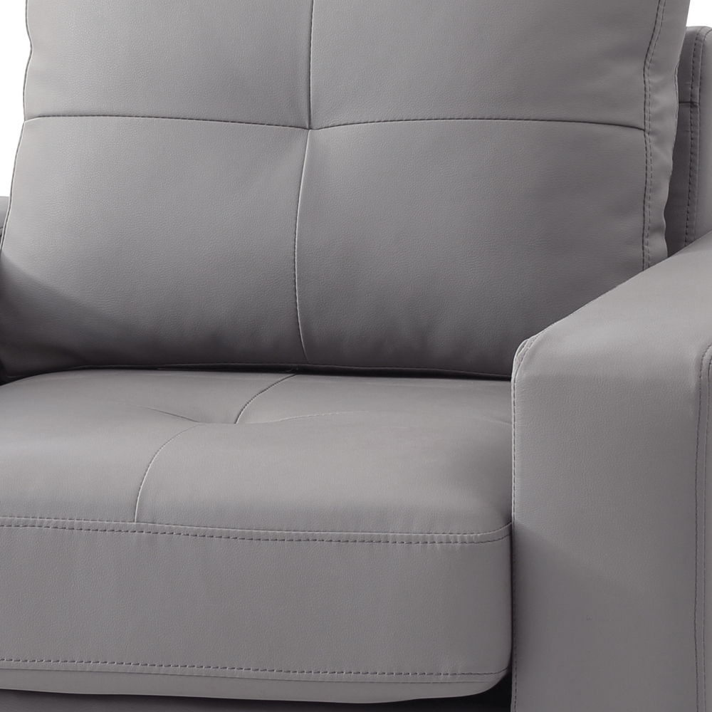 Gray accent chair upholstery close-up with stitched seams and padded arm