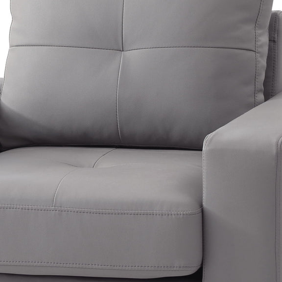 Gray accent chair upholstery close-up with stitched seams and padded arm