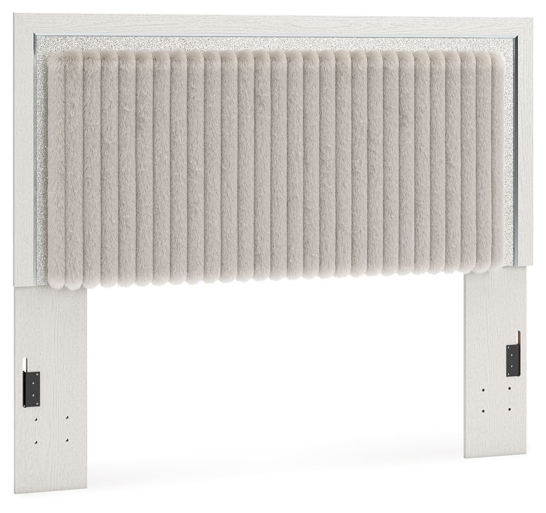 White upholstered panel headboard with vertical tufted channels and scalloped trim