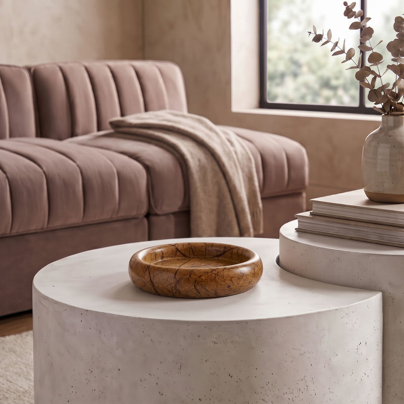 Marble tray in dark brown with veining, placed on a round light stone surface.