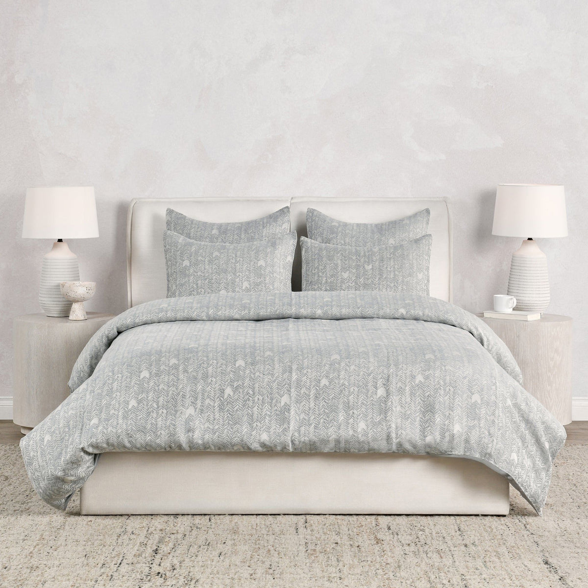 Storm gray French herringbone duvet with matching pillow shams, neatly styled