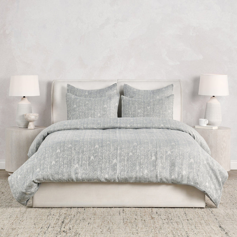 Storm gray French herringbone duvet with matching pillow shams, neatly styled