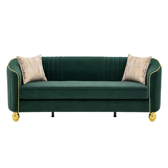 Three-seat dark green sofa with gold trim, fluted back, gold feet, and two beige accent pillows