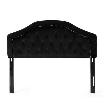 Black tufted fabric headboard with curved top, dark legs, and stitched edge trim.
