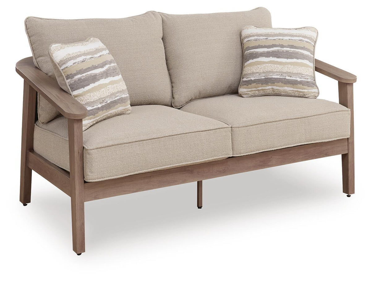 Two-seat outdoor loveseat with beige cushions and two striped throw pillows, shown at an angle