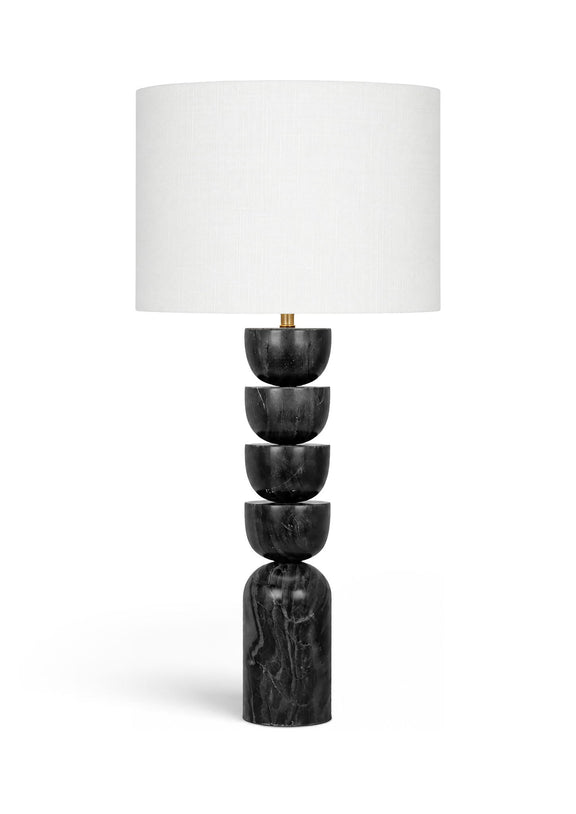 Table lamp with stacked dark marble base and white fabric drum shade, brass accents