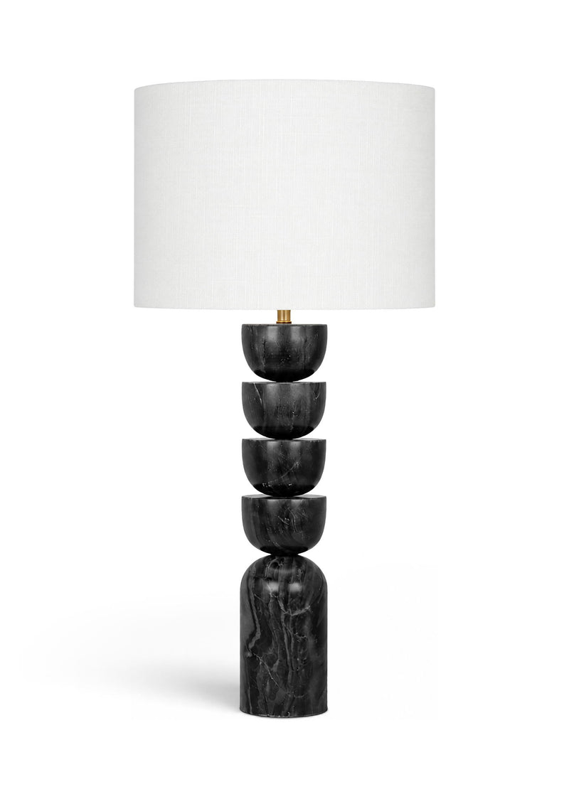 Table lamp with stacked dark marble base and white fabric drum shade, brass accents