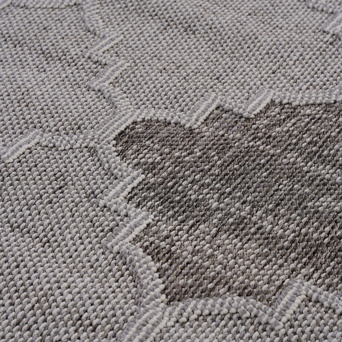 Textured trellis weave on gray and light gray indoor/outdoor area rug