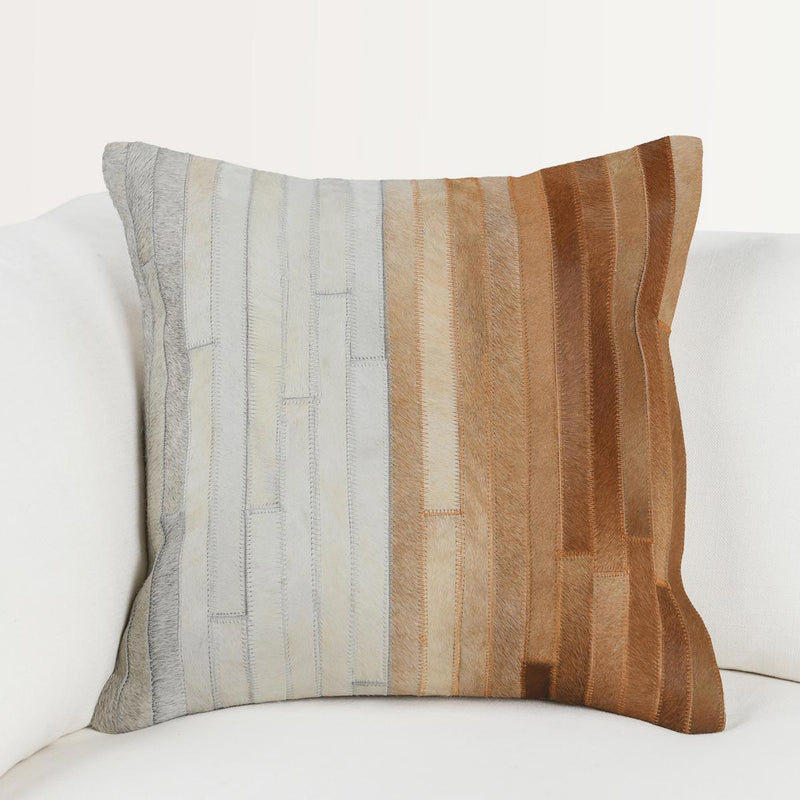 Tan multi hide pillow with striped panels in grey, cream, and rust-brown