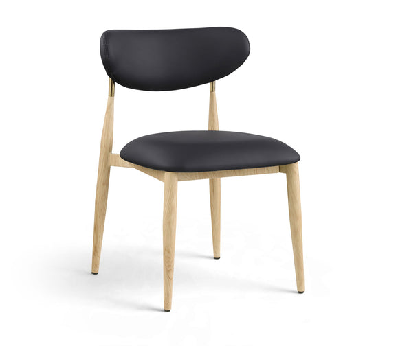 Black upholstered dining side chair with light wood legs and brass accents