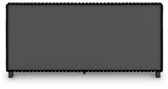 Black upholstered headboard panel with scalloped trim