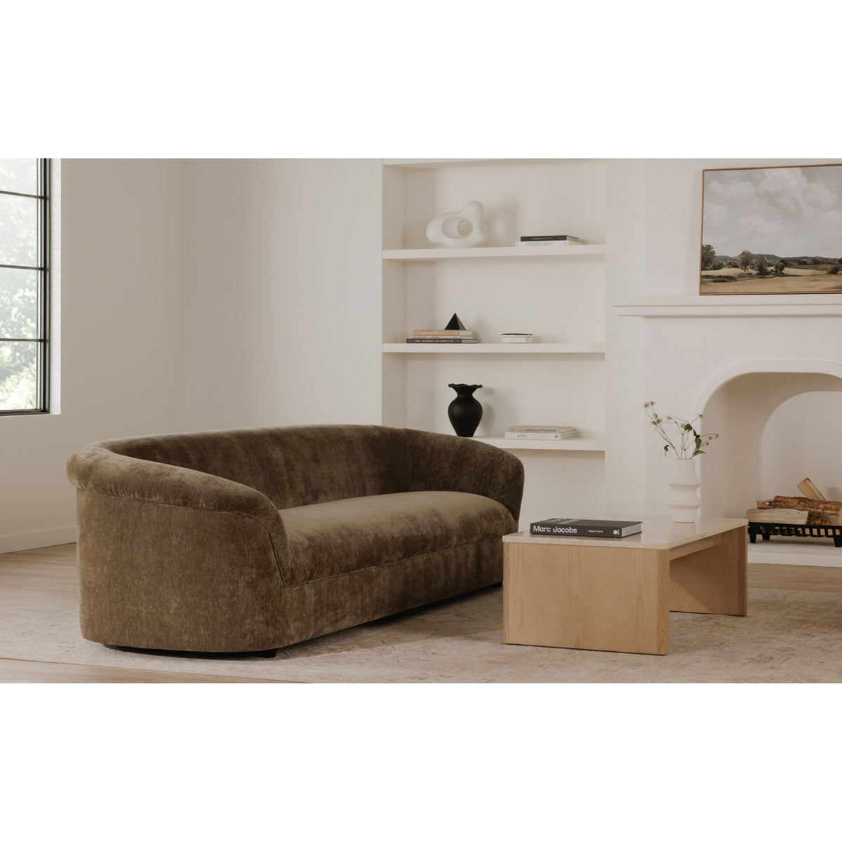 Dark green upholstered sofa with rounded arms and low back, side view