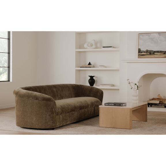 Dark green upholstered sofa with rounded arms and low back, side view