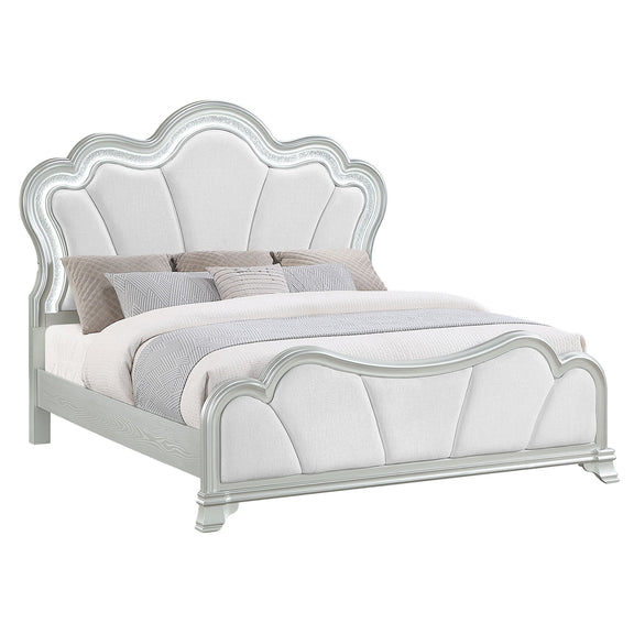 Silver upholstered queen bed with scalloped headboard, curved footboard, and side rails
