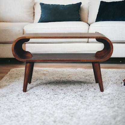 Dark brown solid wood open coffee table with rounded oval cutout shelf and tapered legs.