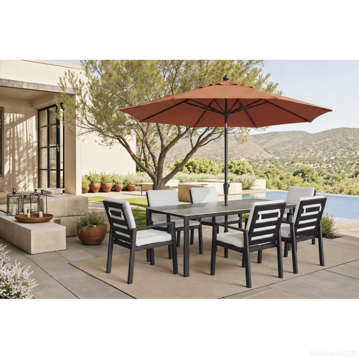 Outdoor dining table with gray top and dark legs, surrounded by matching chairs.