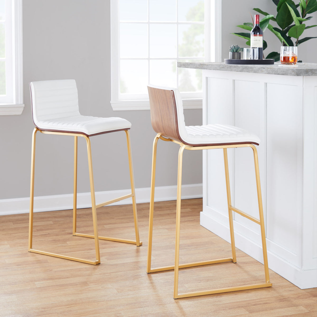 White upholstered fixed-height barstool set of 2 with gold-tone metal legs.