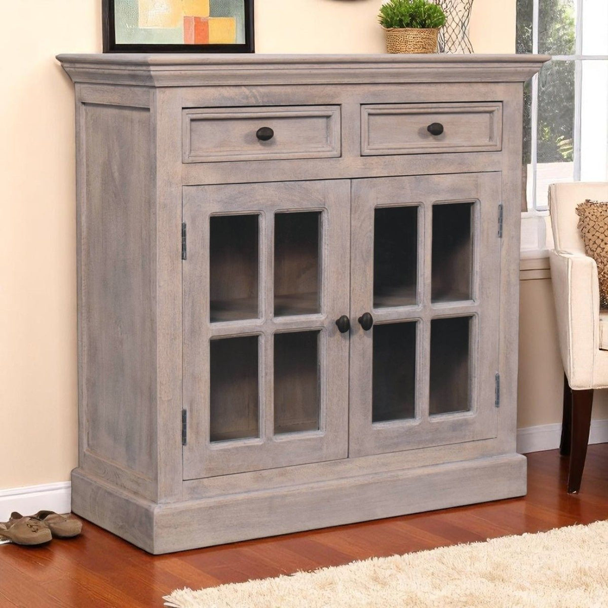 Light gray cabinet with glazed doors and two drawers, with metal knobs.